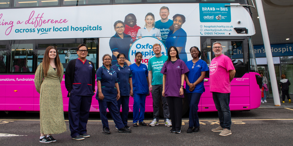 Last year's winners, Oxford Hospitals Charity, stand in front of their newly branded bus.