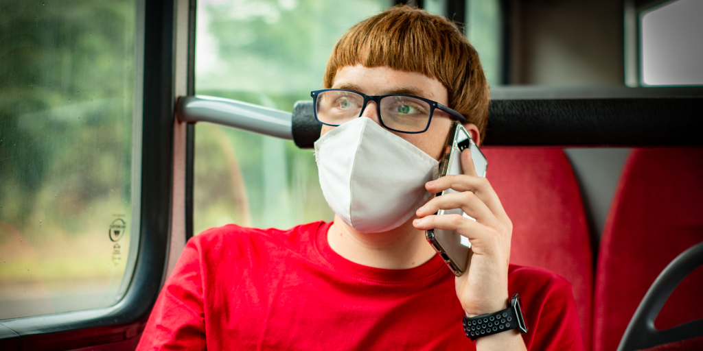 Man wearing a face mask on-board a bus